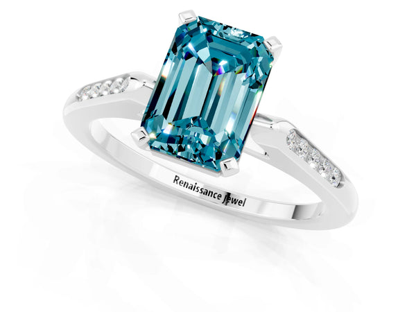 Silver Emerald Cut Blue Topaz Solitaire Ring with Channel Set Round  Band and Prong Setting
