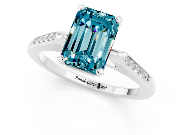Silver Emerald Cut Blue Topaz Solitaire Ring with Channel Set Round  Band and Prong Setting