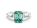 White gold Emerald Cut Cut Diamond Ring with Tapered Baguette Side Stones in Four-Prong Setting