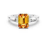 White gold Emerald Cut Cut Diamond Ring with Tapered Baguette Side Stones in Four-Prong Setting