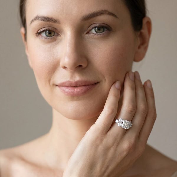 White gold Emerald Cut Diamond Cluster Ring with Round Accent Stones and Prong Setting on a Classic Band