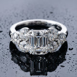 White gold Emerald Cut Diamond Cluster Ring with Round Accent Stones and Prong Setting on a Classic Band_93