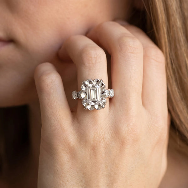 White gold Emerald Cut Diamond Floral Halo Engagement Ring with Shared Prong Setting