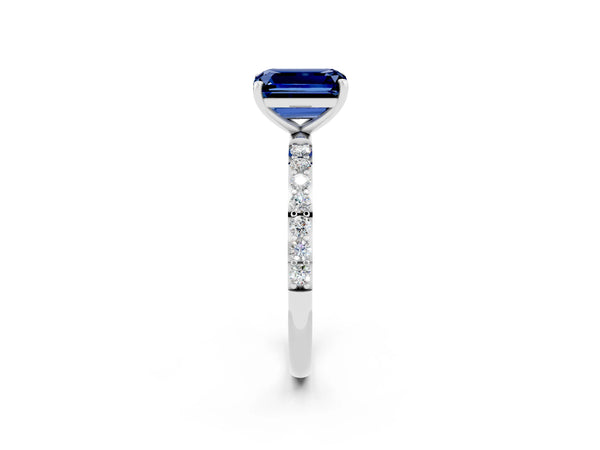 Silver Emerald Cut Blue Sapphire Solitaire Ring with Round Pavé Shoulders and Prong Setting