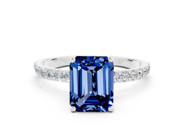 Silver Emerald Cut Blue Sapphire Solitaire Ring with Round Pavé Shoulders and Prong Setting