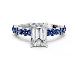 White gold Emerald Cut Diamond Side Stone Solitaire Ring with Round with Blue Sapphire side stone and Four-Prong Setting