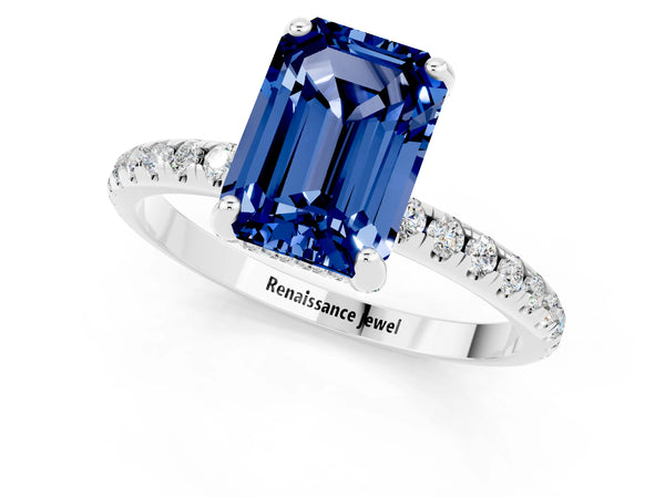 White gold Emerald Cut Blue Sapphire Hidden Halo Engagement Ring with Round Pavé Band and Prong Setting