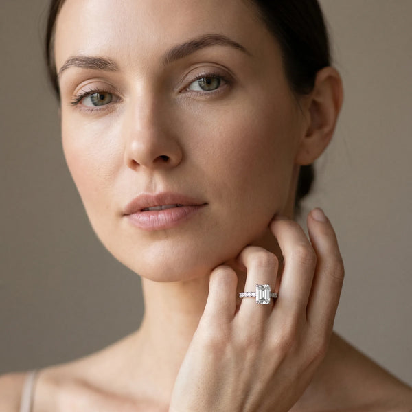 White gold Emerald Cut Diamond Solitaire Ring with Pavé Accents and Four-Prong Setting