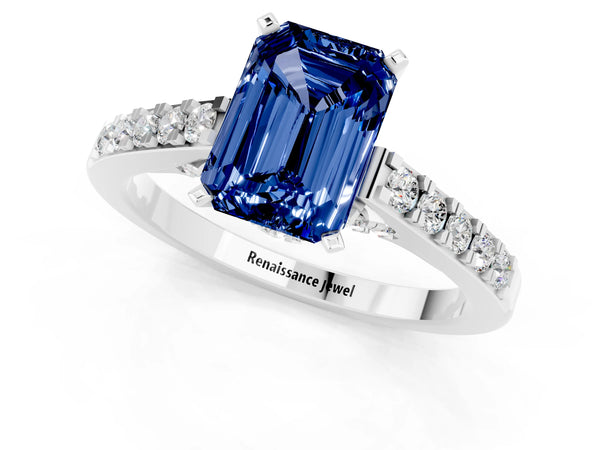 Platinum Emerald Cut Blue Sapphire Solitaire Ring with Crossover Gallery and Round  Pavé Band