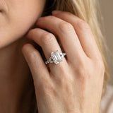 White gold Emerald Cut Diamond Solitaire Ring with Side Stones and Four-Prong Setting_435