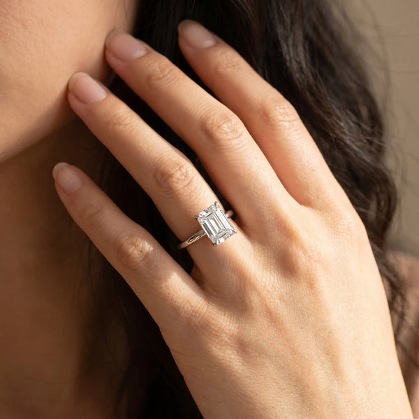 White gold Emerald Cut Diamond Solitaire Ring with Thin Band and Four-Prong Setting