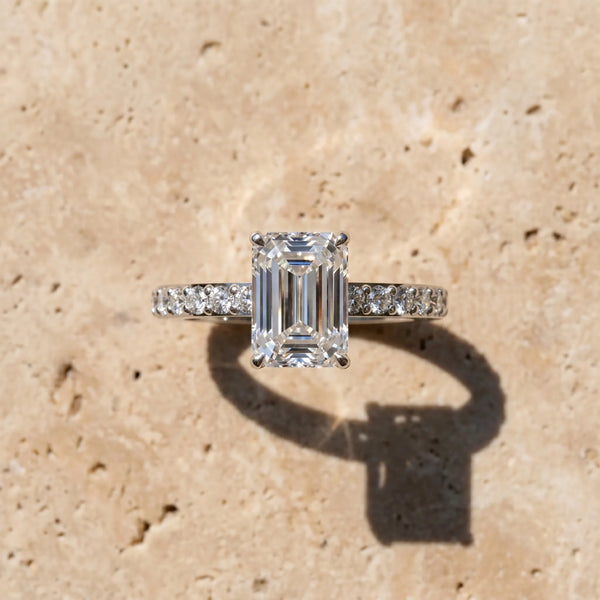 White gold Emerald Cut Diamond Solitaire with Pave Band and Four-Prong Setting