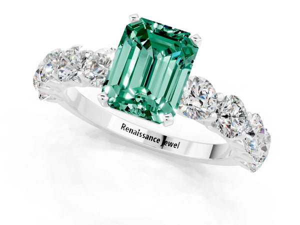 White gold Emerald Cut Green Sapphire Prong Setting with Side Stones on a Pave Band