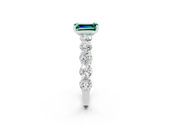Silver Emerald Cut Green Sapphire Prong Setting with Side Stones on a Pave Band
