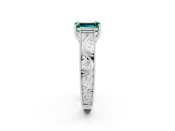 Platinum Emerald Cut Green Sapphire Solitaire Ring with Engraved Band and Four-Prong Setting