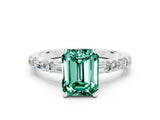 White gold Emerald Cut Green Sapphire Solitaire with Side Baguettes and Channel Set Band