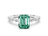 White gold Emerald Cut Green Sapphire Solitaire with Side Stones on a Pavé Band and Four-Prong Setting