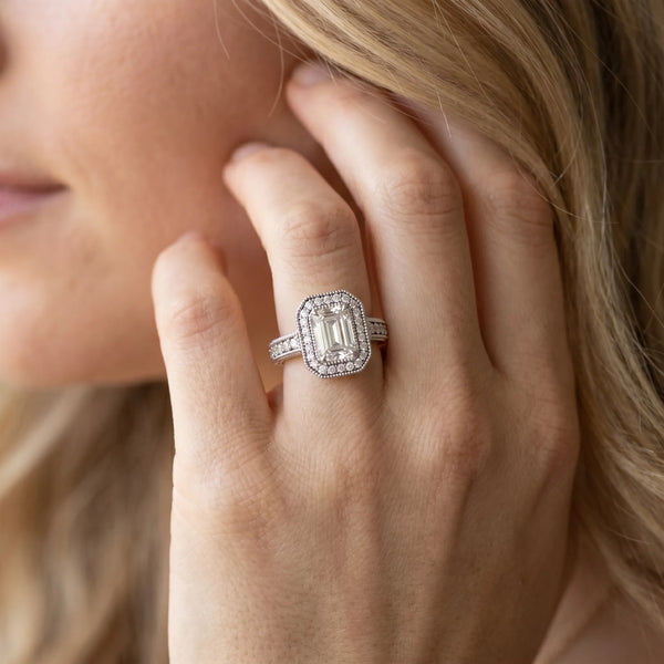 White gold Emerald Cut Halo Diamond Ring with Pavé Band and Four-Prong Setting