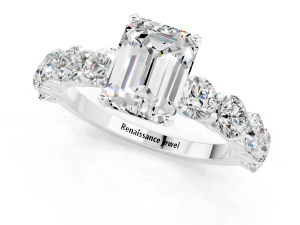 White gold Emerald Cut Moissanite Prong Setting with Side Stones on a Pave Band