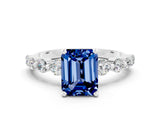 White gold Emerald Cut Solitaire Blue Sapphire Ring with Pave Band and Four-Prong Setting