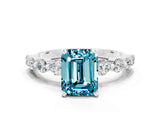 White gold Emerald Cut Solitaire Blue Topaz Ring with Pave Band and Four-Prong Setting
