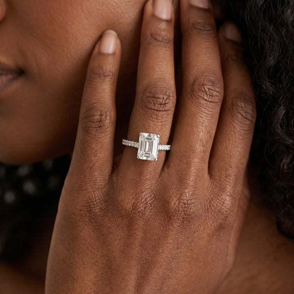 White gold Emerald Cut Solitaire Diamond Ring with Pave Band and Four-Prong Setting