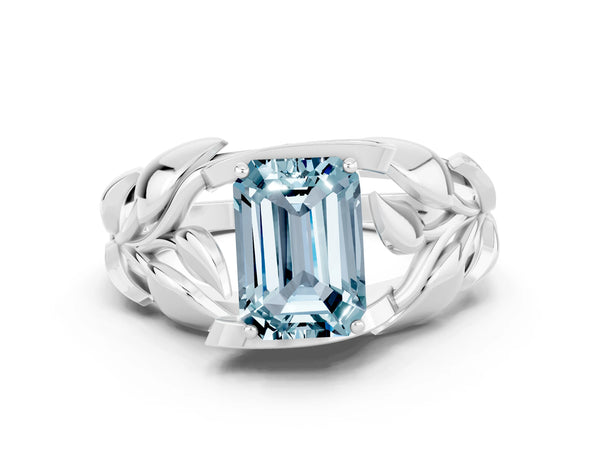 Platinum Emerald Cut Aquamarine Leaf-Inspired Engagement Ring with Round Accents and Prong Setting