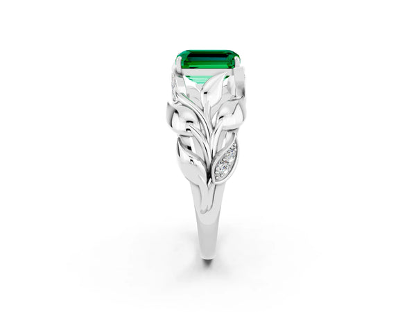 Platinum Emerald Cut Emerald Leaf-Inspired Engagement Ring with Round Accents and Prong Setting