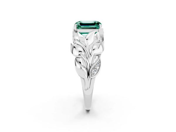 Platinum Emerald Cut Green Sapphire Leaf-Inspired Engagement Ring with Round Accents and Prong Setting