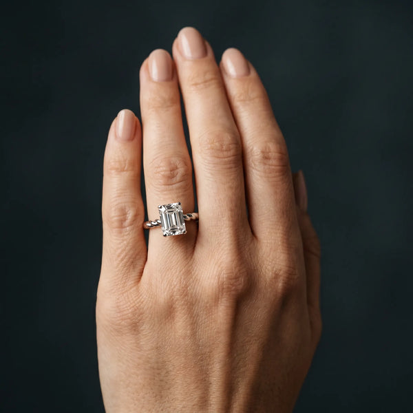 White gold Emerald Cut Solitaire Twisted Band with Four-Prong Setting