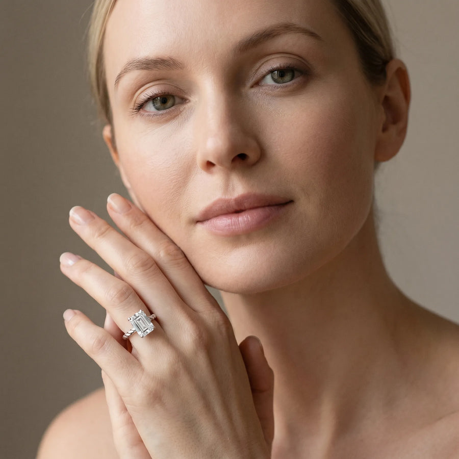 White gold Emerald Cut Solitaire Twisted Band with Four-Prong Setting