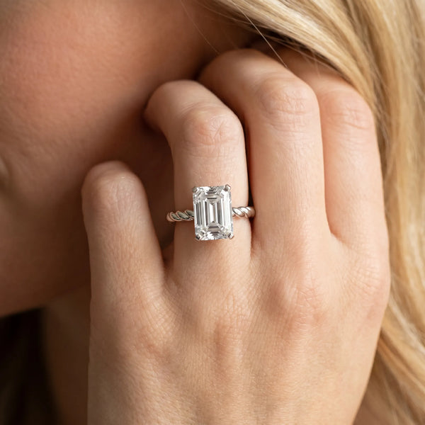 White gold Emerald Cut Solitaire Twisted Band with Four-Prong Setting