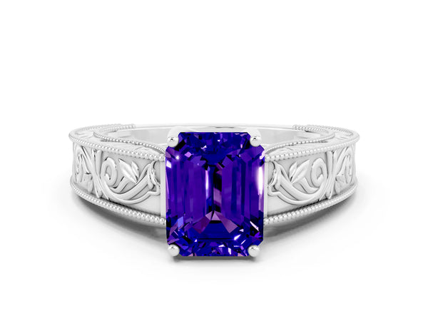 Platinum Emerald Cut Tanzanite Solitaire Ring with Engraved Band and Four-Prong Setting