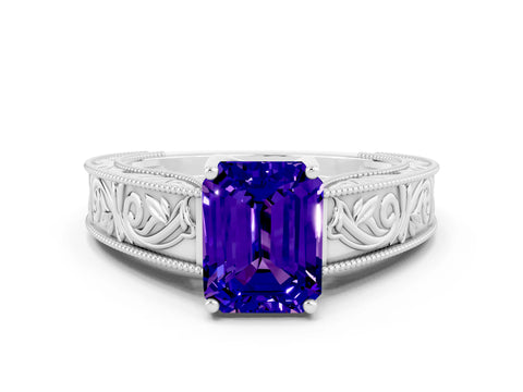 White gold Emerald Cut Tanzanite Solitaire Ring with Engraved Band and Four-Prong Setting