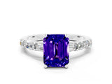 White gold Emerald Cut Tanzanite Solitaire with Side Baguettes and Channel Set Band