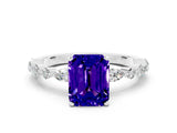 White gold Emerald Cut Tanzanite Solitaire with Side Stones on a Pavé Band and Four-Prong Setting