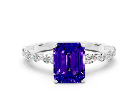 White gold Emerald Cut Tanzanite Solitaire with Side Stones on a Pavé Band and Four-Prong Setting
