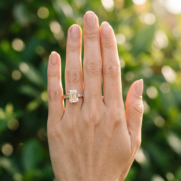 White gold Emerald Solitaire Diamond Ring with Channel-Set Baguette Band and Four-Prong Setting