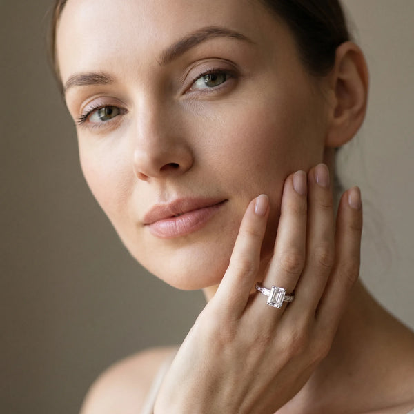 White gold Emerald Solitaire Diamond Ring with Channel-Set Baguette Band and Four-Prong Setting