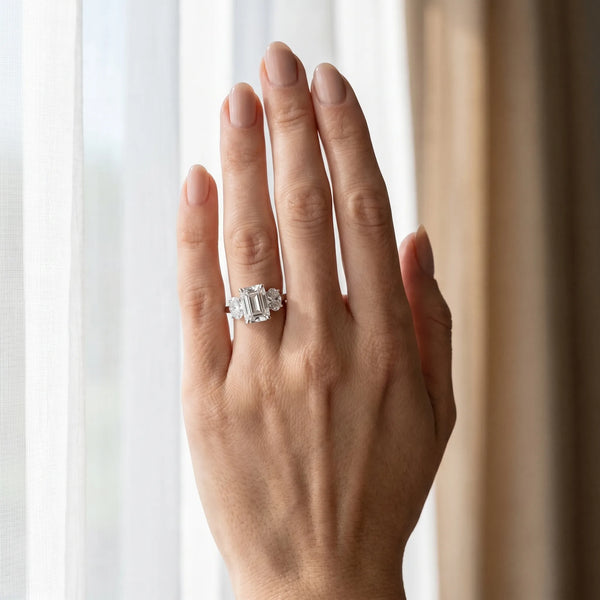 White gold Emerald Three-Stone Diamond Ring with Prong Setting on a Classic Band