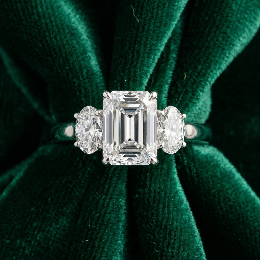 White gold Emerald Three-Stone Diamond Ring with Prong Setting on a Classic Band