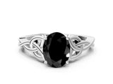 White gold Fancy Black Oval Cut Diamond Solitaire Engagement Ring with Celtic Knot Band and Four-Prong Setting