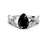 White gold Fancy Black Pear Cut Diamond Solitaire Ring with Four-Prong Setting and Twisted Pavé Band