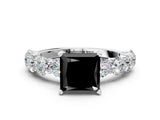 White gold Fancy Black Princess Cut Diamond Prong Setting with Side Stones on a Pave Band
