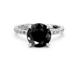 White gold Fancy Black Round Cut Diamond Brilliant Solitaire Ring with Pavé Band and Four-Prong Setting