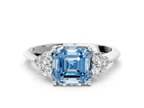 White gold Fancy Blue Asscher Cut Cut Diamond Cluster Ring with Solitaire Band and Four-Prong Setting