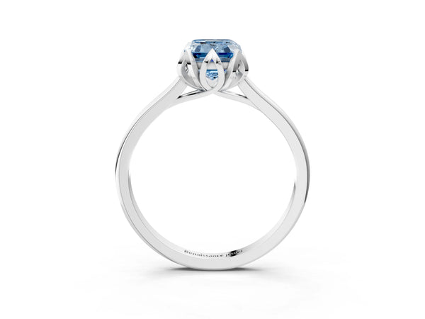 White gold Fancy Blue Emerald Cut Diamond Solitaire Ring with Flower Prong Setting and Classic Band