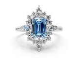 White gold Fancy Blue Emerald Cut Halo Diamond Cluster Ring with Marquise and Round Stones on a White Gold Band with Prong Setting
