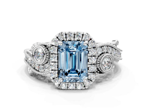 White gold Fancy Blue Emerald Cut Halo Diamond Ring with Milgrain and Bezel Accents on a Split Shank Band