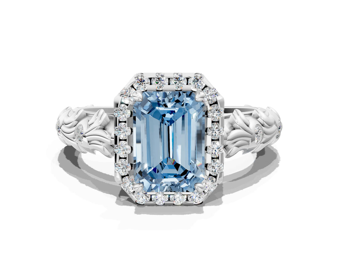 White gold Fancy Blue Emerald Cut Halo Diamond Solitaire with Filigree Band and Four-Prong Setting
